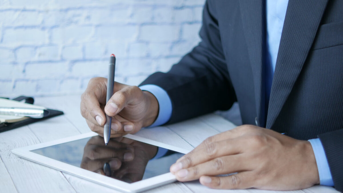 man in a suit using hr software for attendance management